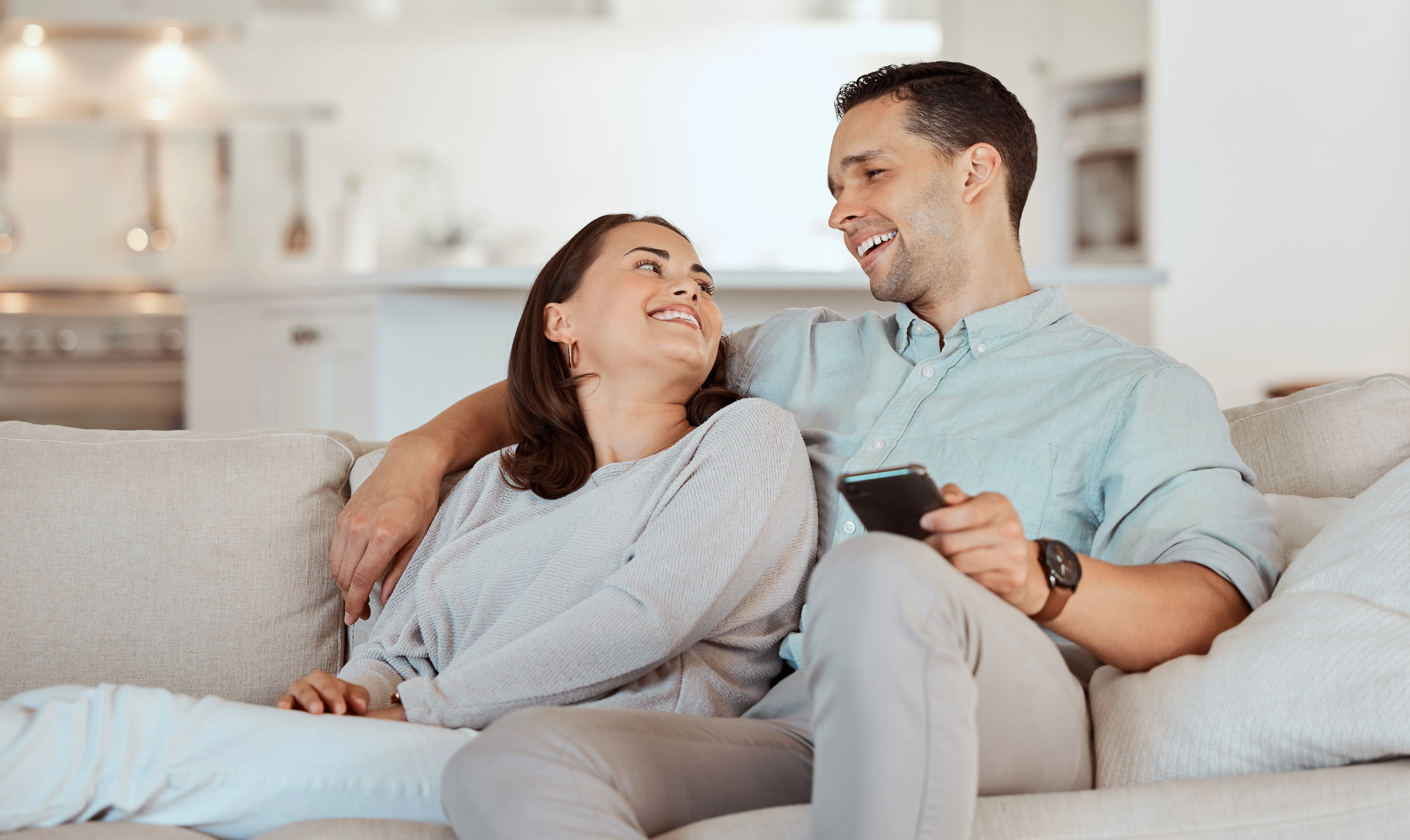 A relaxed couple sitting together at home