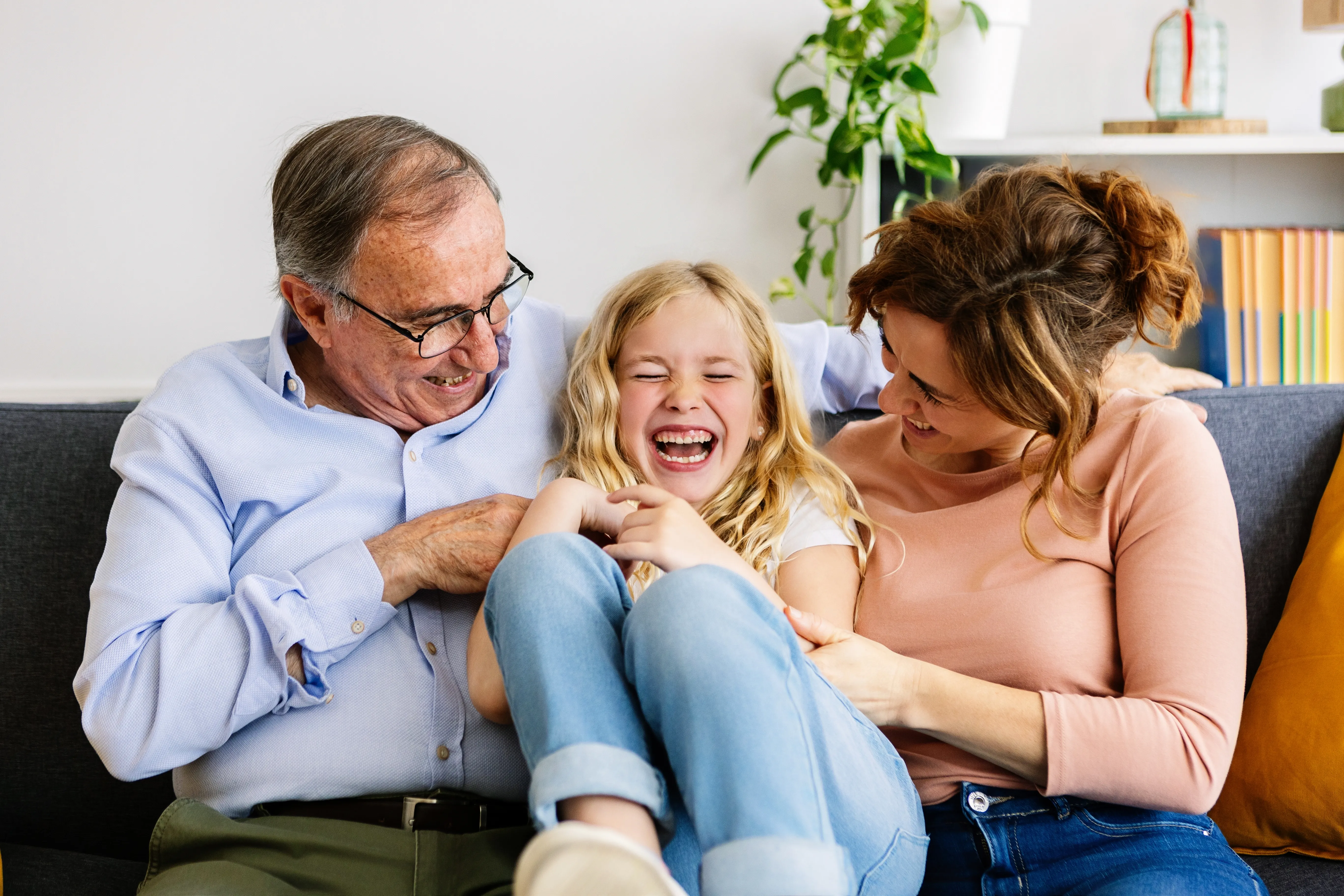 A smiling family sitting together at home