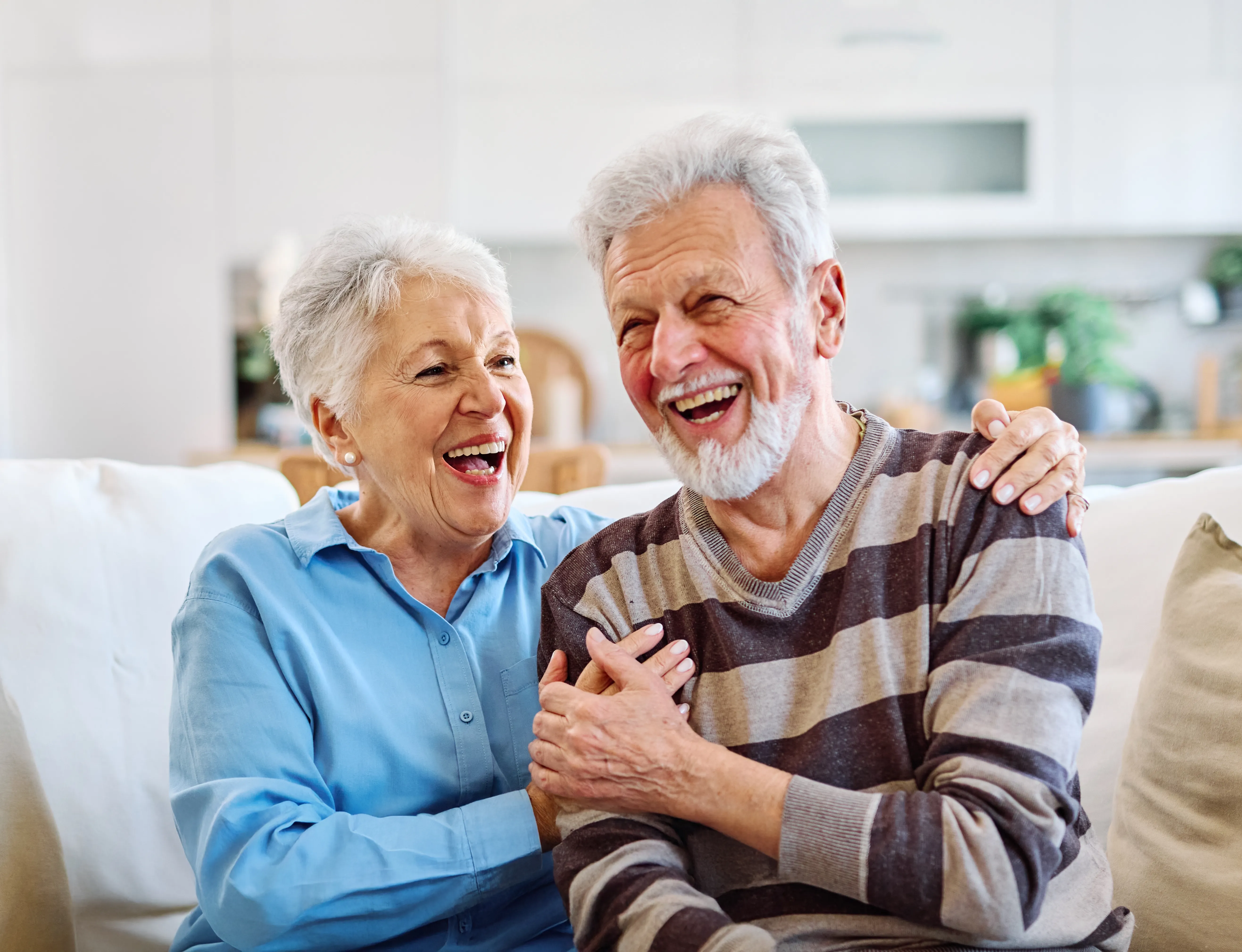 An older couple laughing together