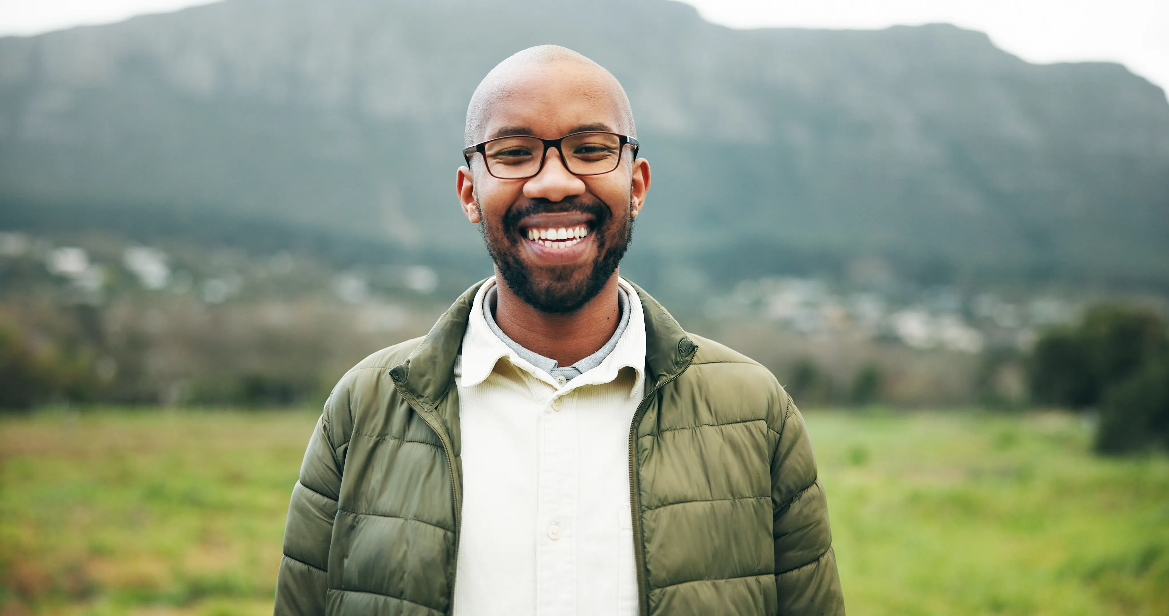 A smiling adult outdoors