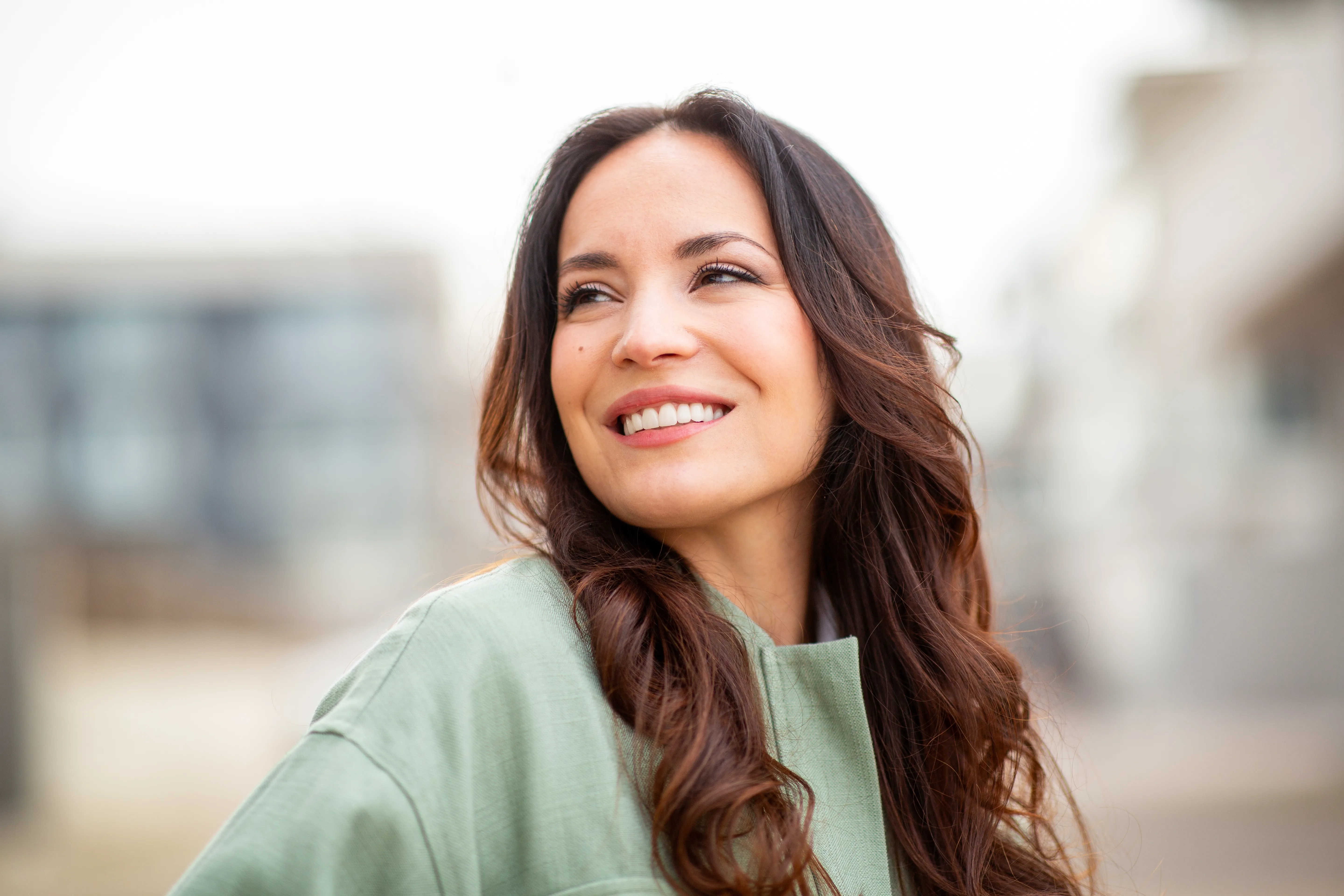 A woman smiling in a bright room